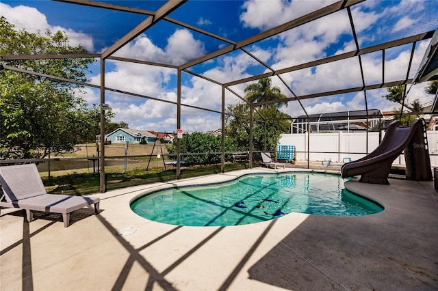 view of swimming pool with a fenced in pool, glass enclosure, a patio area, a water slide, and a fenced backyard