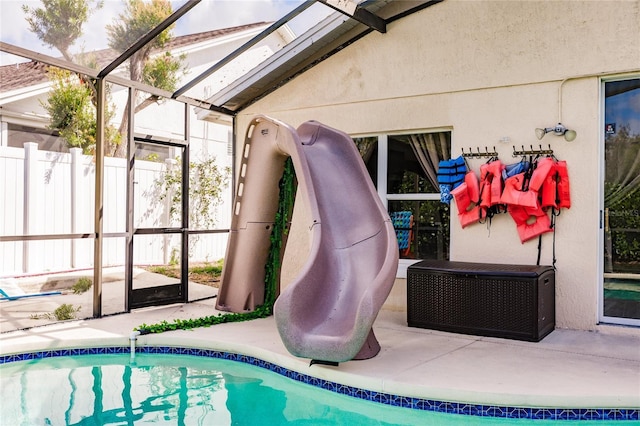 view of pool featuring a lanai, fence, a fenced in pool, and a patio