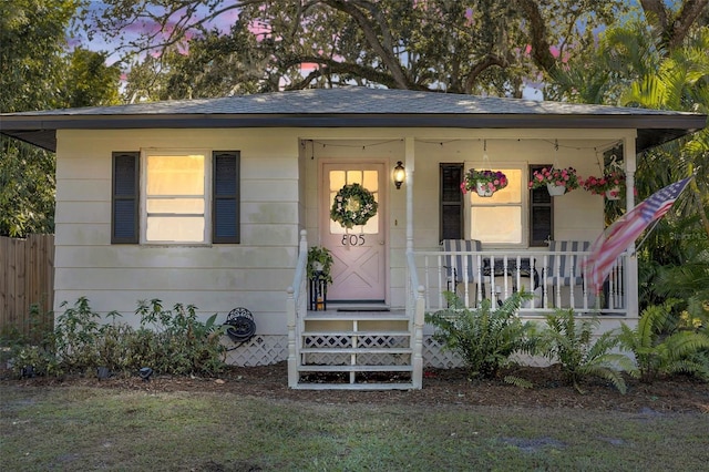 exterior entry at dusk featuring covered porch