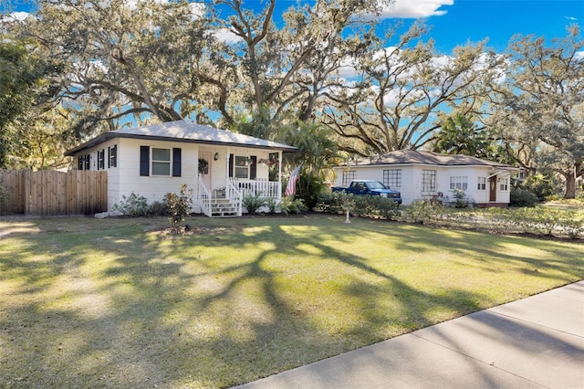 single story home with a porch and a front lawn