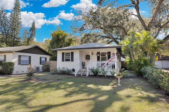 view of front of home featuring a porch, a front yard, and central AC