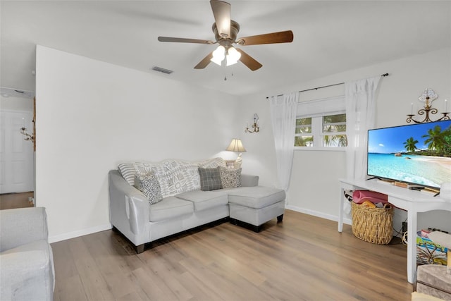 living room with hardwood / wood-style flooring and ceiling fan