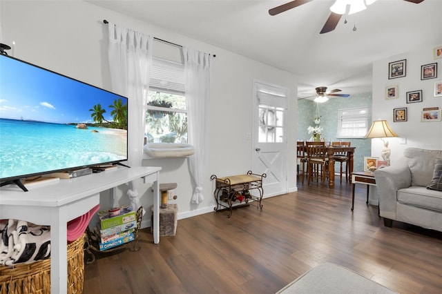 living room with dark hardwood / wood-style flooring and ceiling fan