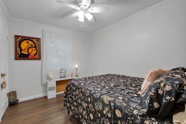 bedroom featuring dark hardwood / wood-style flooring, ceiling fan, and crown molding