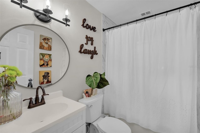 bathroom featuring vanity, toilet, and walk in shower