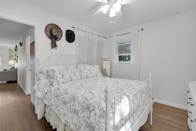 bedroom with ceiling fan and dark hardwood / wood-style floors