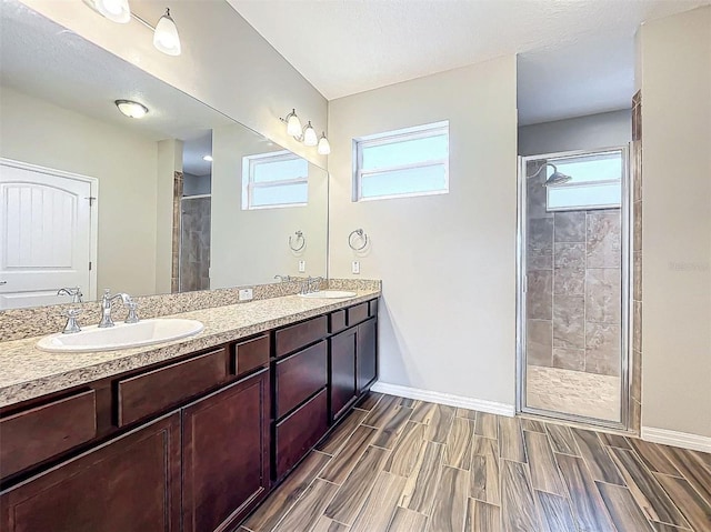 bathroom with vanity and a shower with door