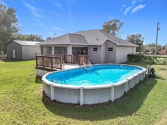 view of pool with a lawn and a deck