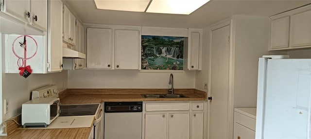 kitchen featuring white cabinets, white appliances, washer / clothes dryer, and sink