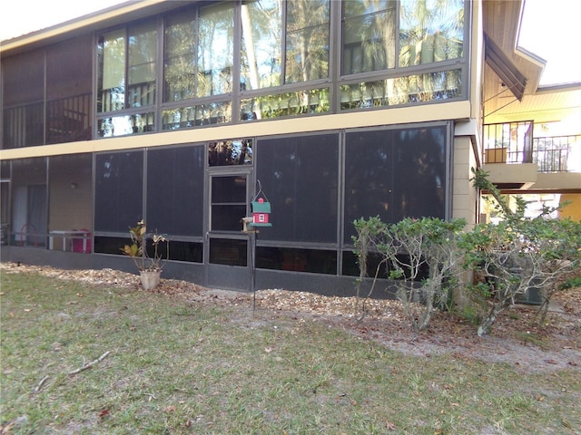 exterior space with a sunroom and a yard