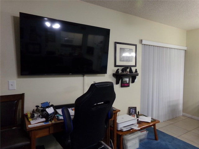 office area featuring tile patterned flooring and a textured ceiling