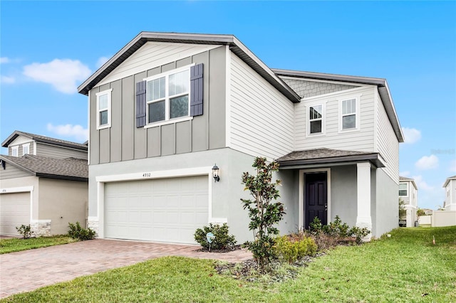 view of front of home featuring a garage and a front yard