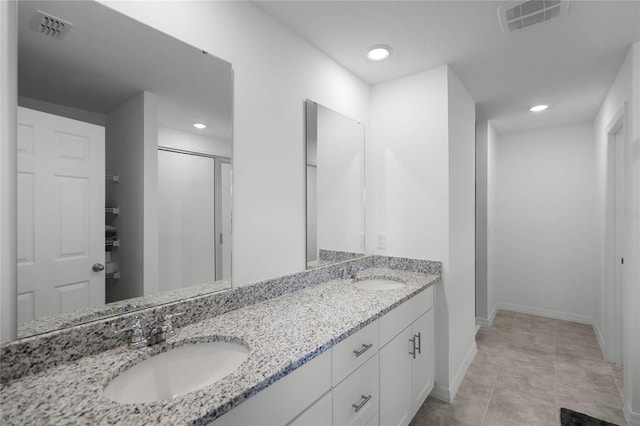 bathroom featuring tile patterned floors, vanity, and walk in shower