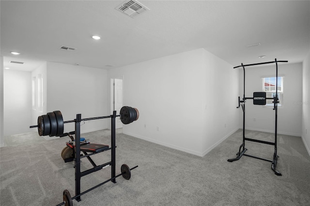 workout area featuring light colored carpet