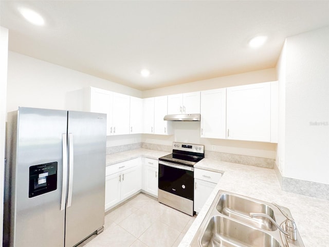 kitchen featuring white cabinetry, sink, light tile patterned flooring, and appliances with stainless steel finishes