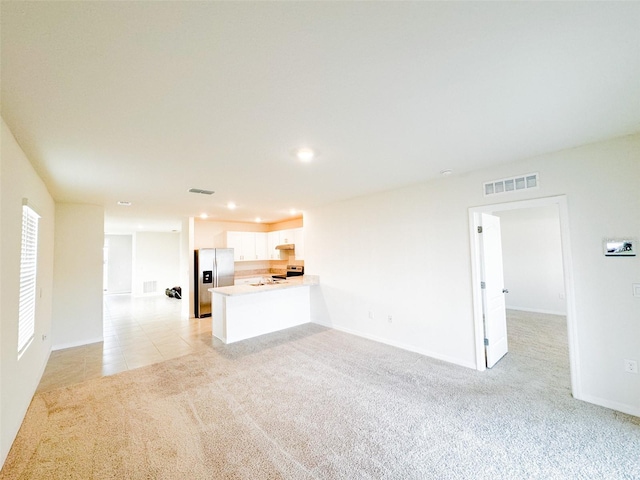 unfurnished living room with light carpet