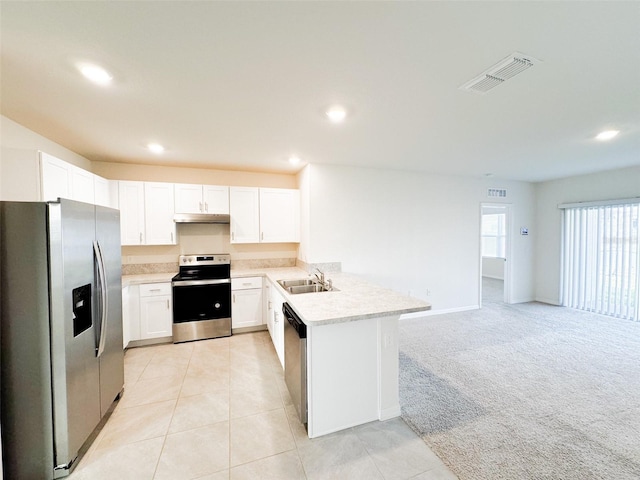 kitchen with kitchen peninsula, stainless steel appliances, light colored carpet, sink, and white cabinets