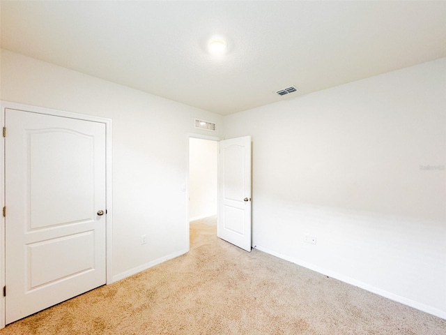 unfurnished room with light carpet