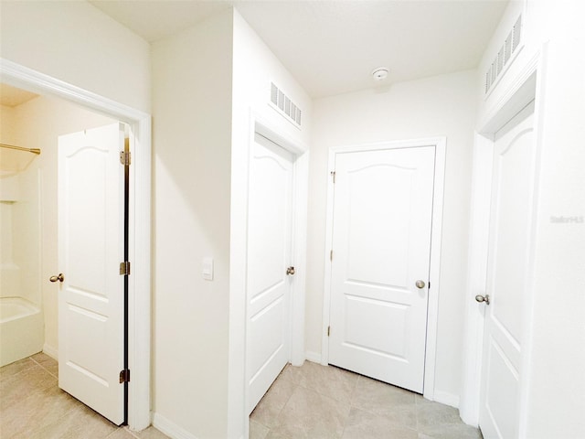 corridor featuring light tile patterned flooring