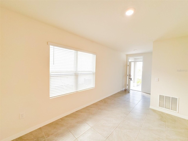 unfurnished room featuring light tile patterned floors