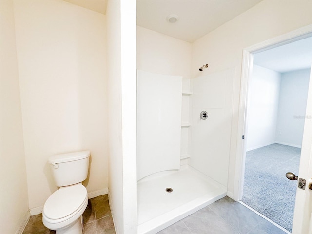 bathroom with a shower and toilet