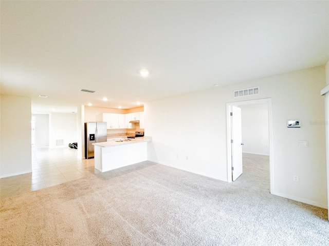 unfurnished living room with light carpet