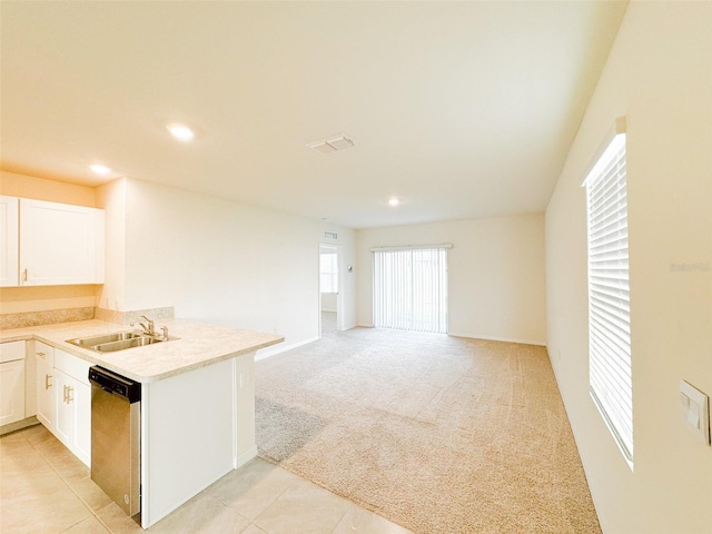 kitchen featuring light carpet, white cabinets, sink, stainless steel dishwasher, and kitchen peninsula