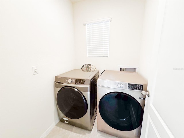 laundry area with light tile patterned flooring and independent washer and dryer