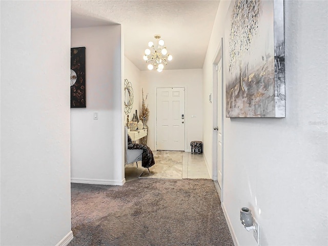 corridor featuring a chandelier and light colored carpet