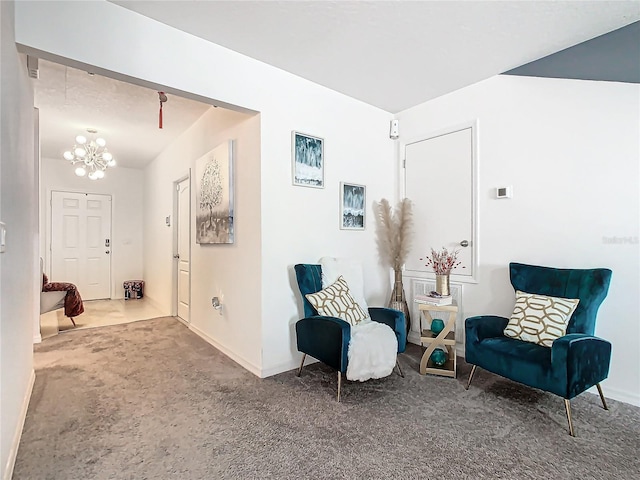 living area featuring a notable chandelier and carpet floors