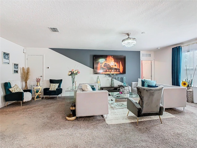 living room featuring a textured ceiling and carpet floors