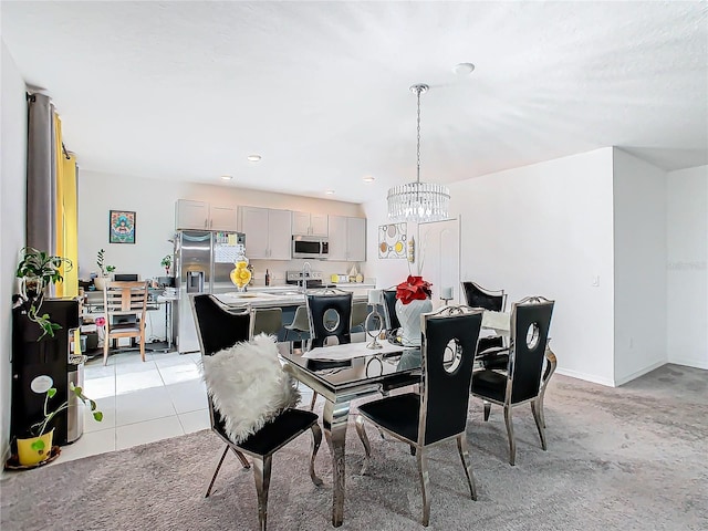 dining space featuring light tile patterned floors and an inviting chandelier