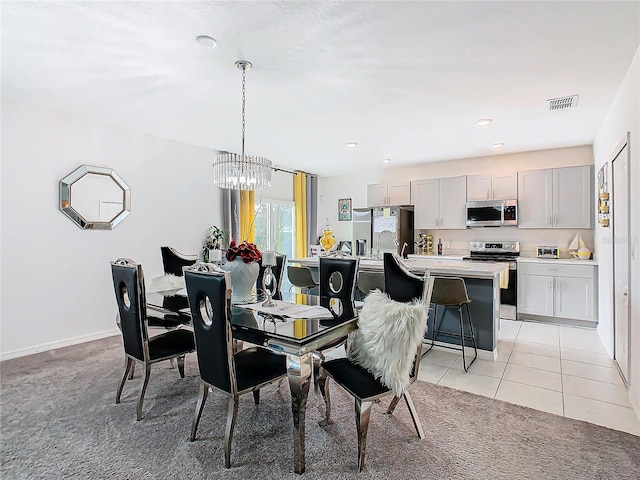 dining area with light tile patterned floors and a notable chandelier