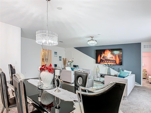 dining room featuring a chandelier and light colored carpet