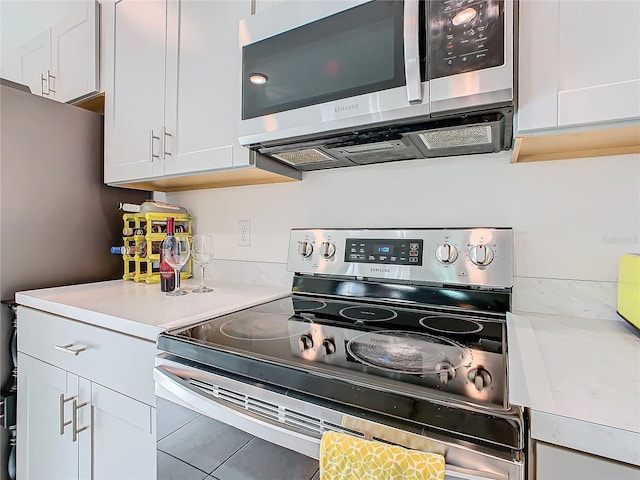 kitchen featuring appliances with stainless steel finishes and white cabinetry