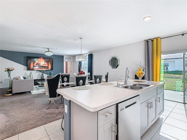 kitchen with dishwasher, sink, hanging light fixtures, a center island with sink, and light tile patterned floors