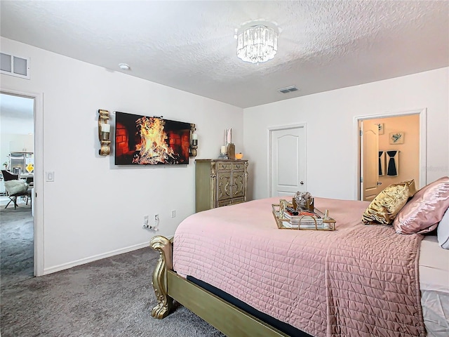 bedroom featuring carpet flooring, a notable chandelier, and a textured ceiling