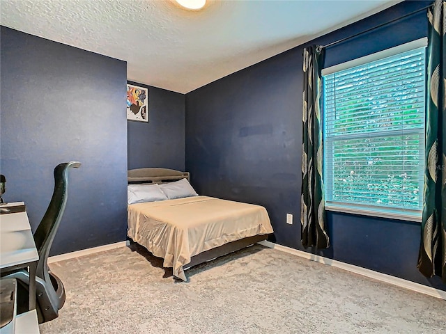 bedroom with carpet flooring and a textured ceiling