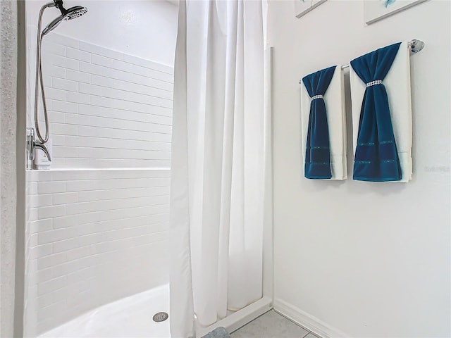 bathroom with tile patterned floors and walk in shower