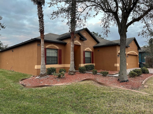 view of front of house with a front yard and a garage