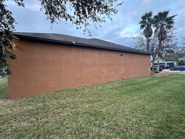 view of side of property with a lawn