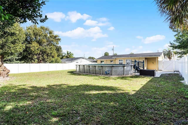 view of yard with a fenced in pool