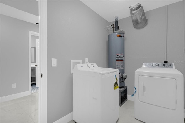 washroom with gas water heater and separate washer and dryer