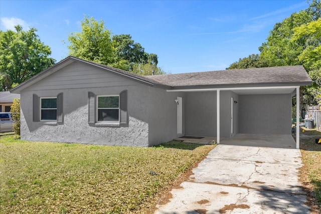 ranch-style home with a carport and a front lawn