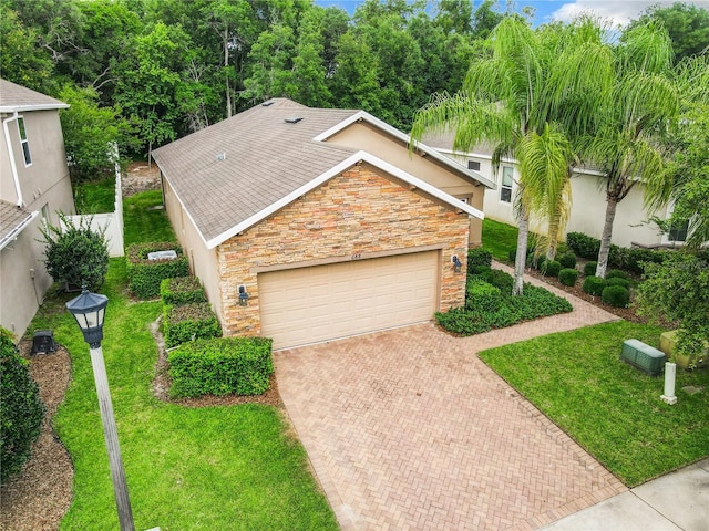 view of front of house with a garage and a front yard