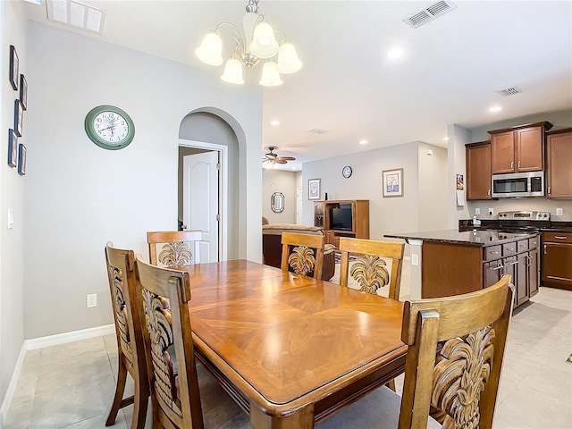 dining room featuring ceiling fan with notable chandelier