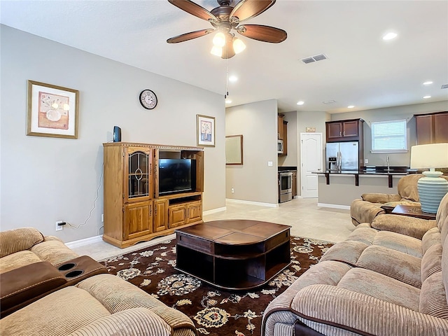 tiled living room featuring ceiling fan