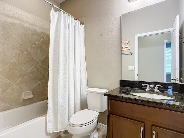 full bathroom with vanity, shower / tub combo, and toilet