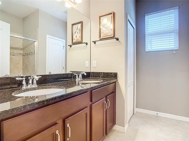 bathroom featuring tile patterned flooring, vanity, and a shower with shower door