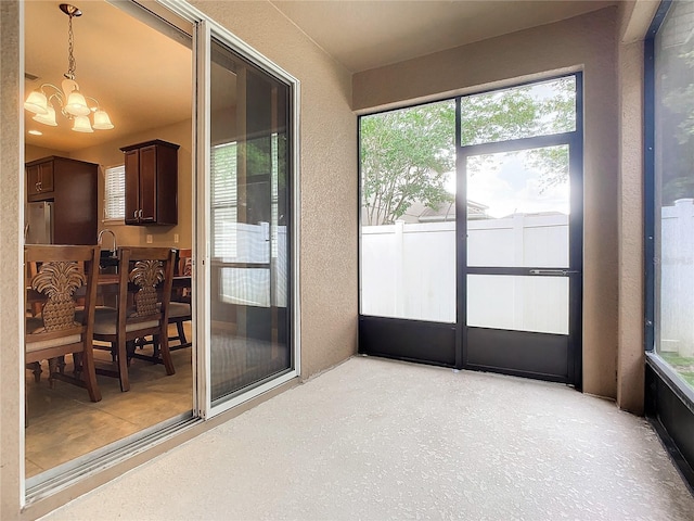 sunroom featuring a notable chandelier